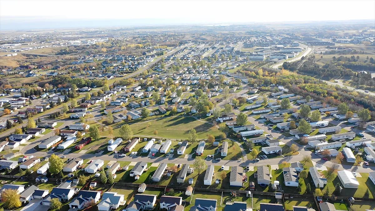 Homes along a tree-lined street in an Elevation Capital Group manufactured housing community